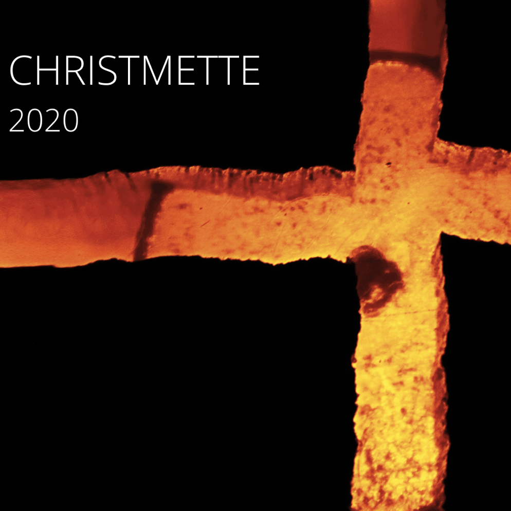 Christmette 2020: Abbildung eines goldenen Kreuzes vor schwarzem Hintergrund.